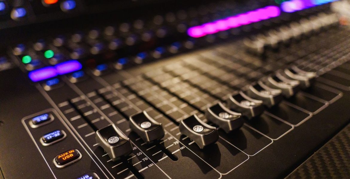 Detailed view of an advanced audio mixing console, perfect for studios.